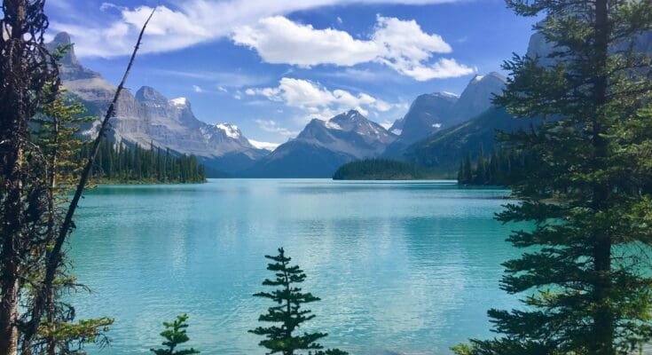 Cruising- Maligne -Lake Vibrant- Blue- Waters -and- Towering -Peaks